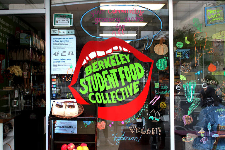 Picture of a storefront with a large mouth logo with "Berkeley Student Food Collective" inside the mouth