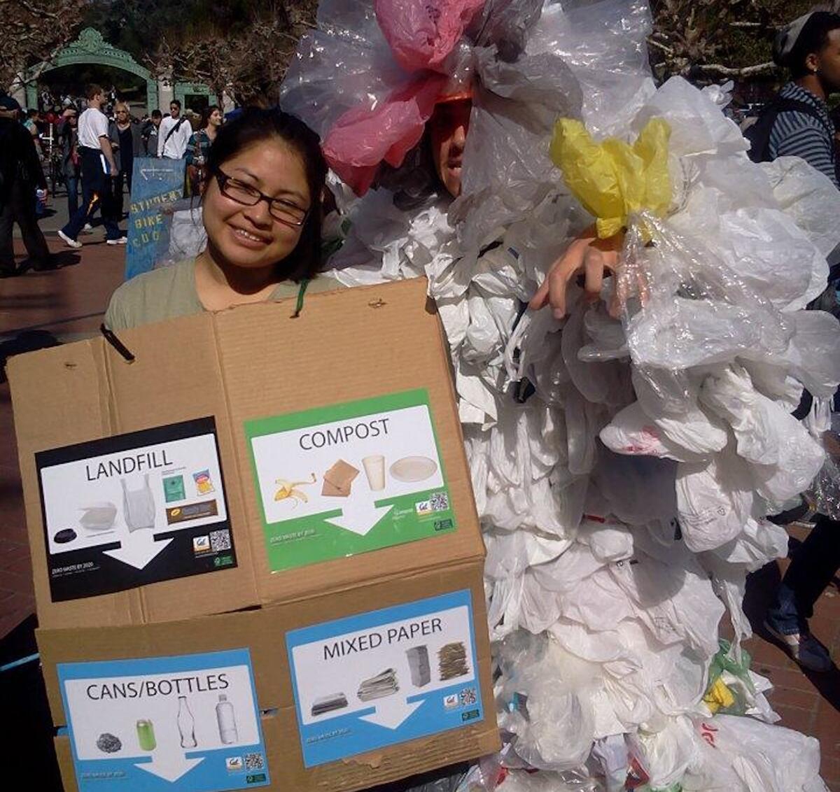 Person holding compost headlines with bags of trash that resemble balloons