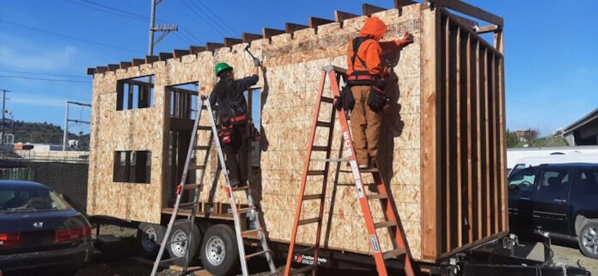 Builders working on a tiny home